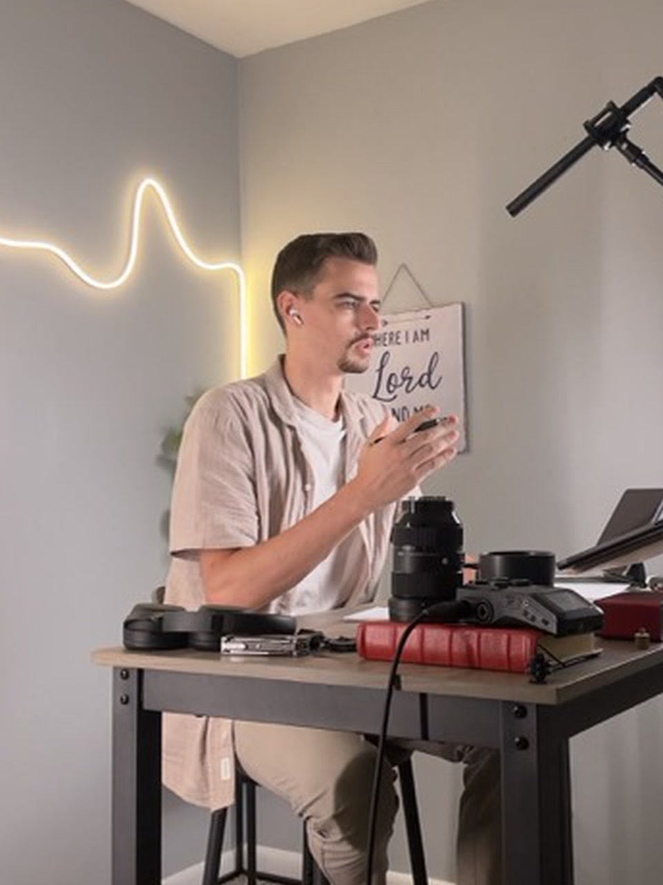 Tabor Normoyle teaching online at a desk with camera and audio equipment.